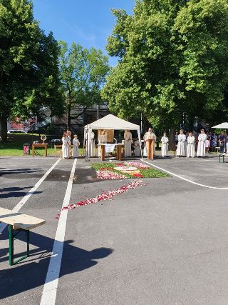 im Vordergrund der Schulhof vor der Kirche, im Hintergrund das Zelt