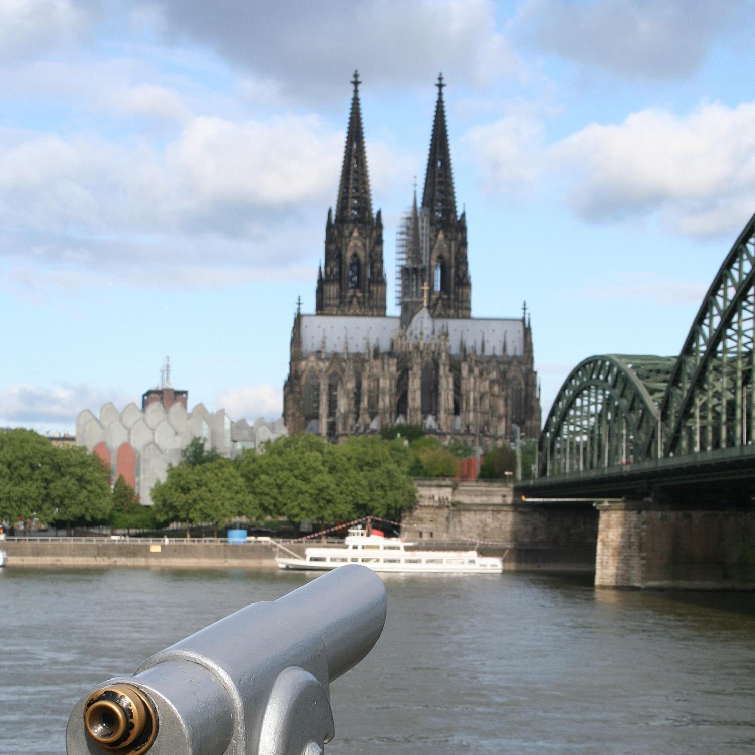 Blick von der gegenüberliegenden Rheinseite auf den Dom, im Vordergrund ein Fernrohr