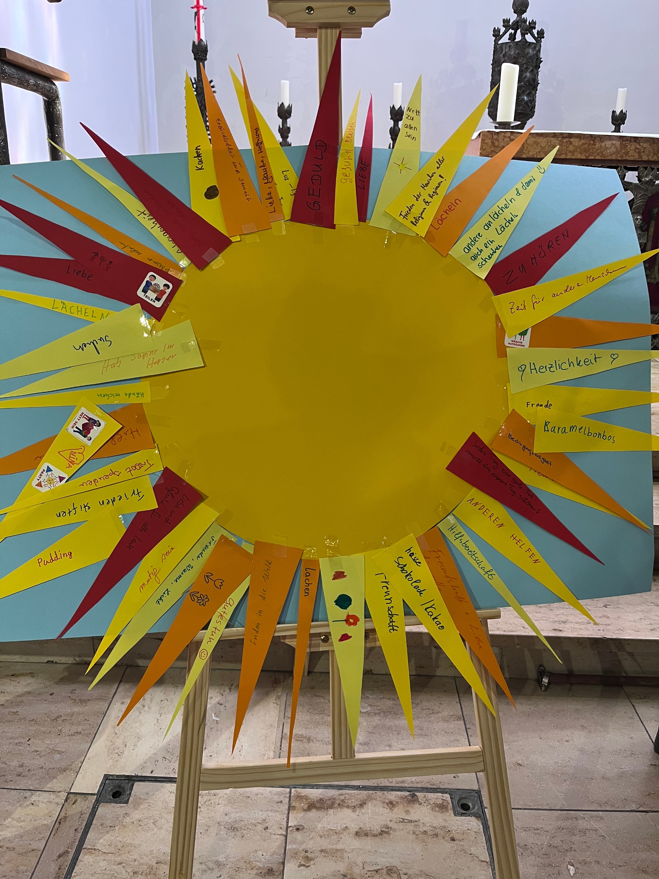 Auf einer Staffelei eine große Sonne aus gelbem Karton